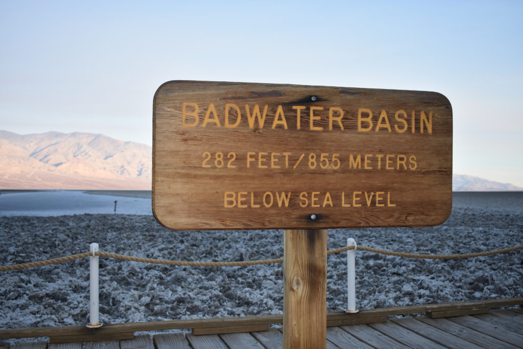 sign displaying -282 feet below sea level with salt flat behind