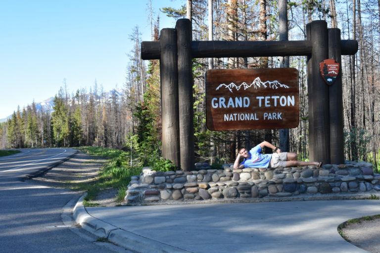 Man by entrance to Grand Teton National Park