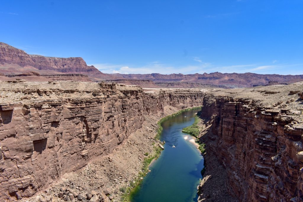 Deep canyon with bright green river flowing
