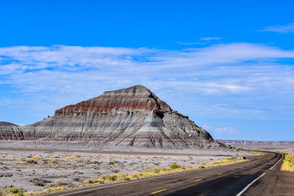 Conical shaped rock formation with colorful layers