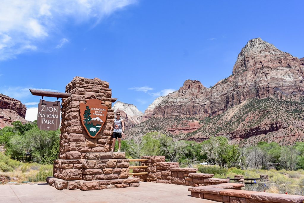 guy standing at entrance of Zion National Park